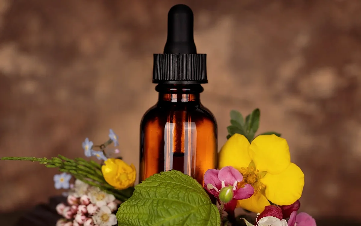 Amber dropper bottle with fresh flowers
